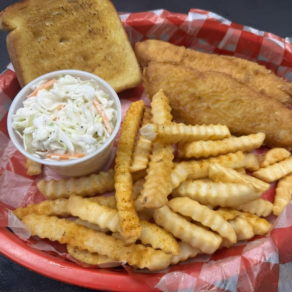 Smokin' Jim's fried fish, crinkle-cut fries, coleslaw, and Texas toast in a red basket.