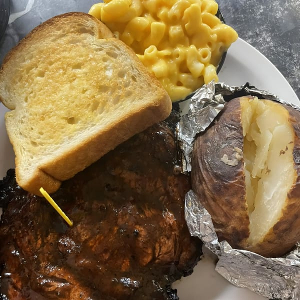 Smokin’ Jim's BBQ ribs with mac and cheese, garlic toast, and a baked potato.